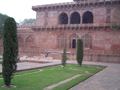 In front of the Taj museum, a stonemason-wallah chips away, presumably at some restoration work on the red stone from which the walls to the complex are constructed.