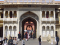 Tourists milling around one of the beautifully ornate gates inside the Palace complex.