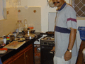 Jeffrey in the kitchen, cooking up some traditional Goan spicy sausages.