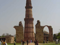 The tower is surrounded by ruins of mosques and other ancient buildings.